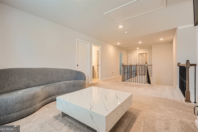 living room featuring light carpet, attic access, and recessed lighting