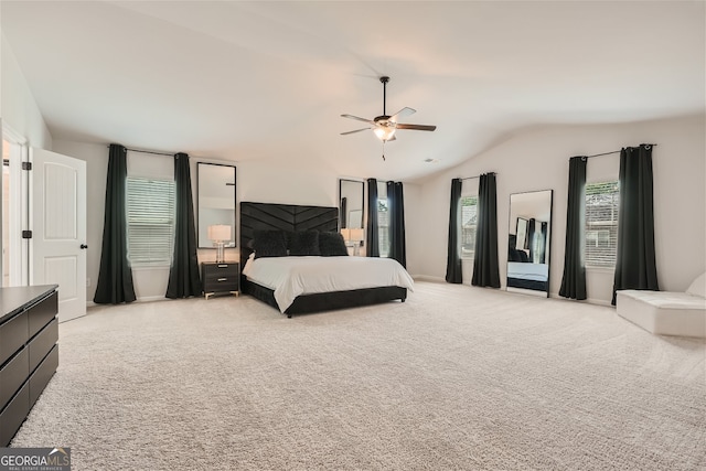 bedroom with ceiling fan, vaulted ceiling, and light carpet