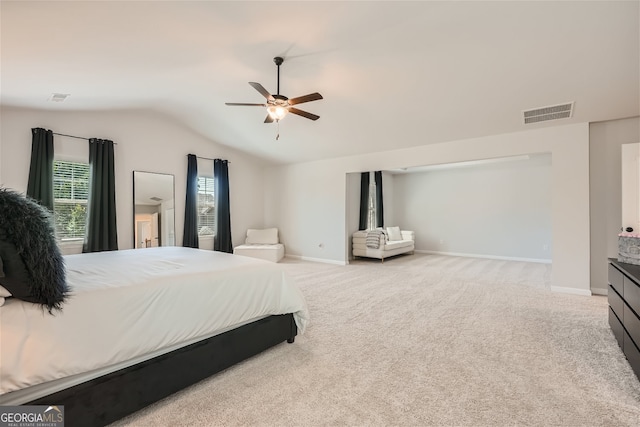 bedroom featuring lofted ceiling, ceiling fan, and light colored carpet