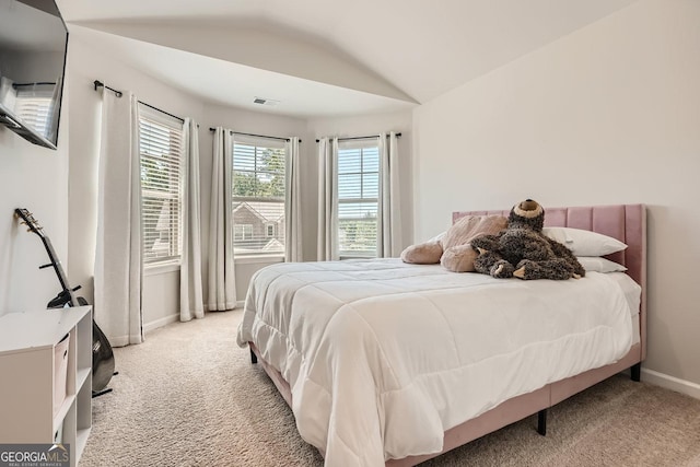 bedroom featuring vaulted ceiling, baseboards, visible vents, and light colored carpet