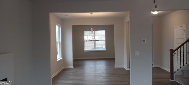 interior space with dark hardwood / wood-style floors and a notable chandelier