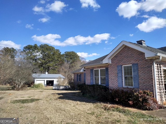 view of side of home with an outbuilding and a garage