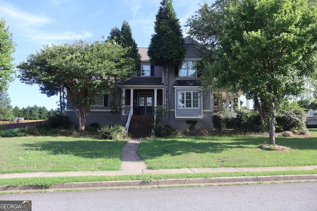 view of front facade featuring covered porch and a front lawn