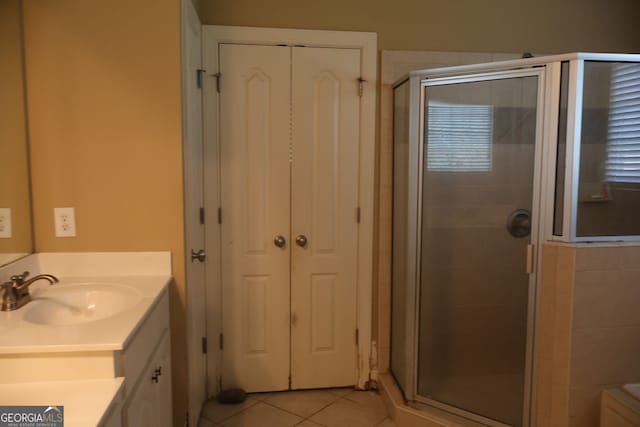 bathroom with vanity, walk in shower, and tile patterned floors