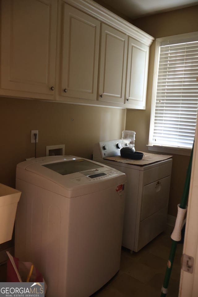 laundry area with cabinets, tile patterned flooring, and washing machine and clothes dryer