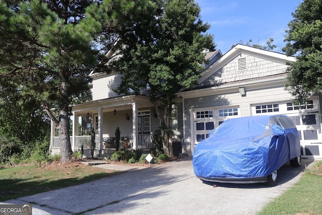 view of front of property featuring a porch and a garage