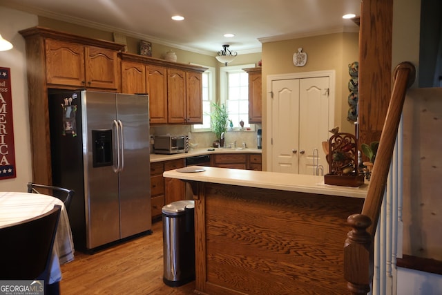 kitchen featuring stainless steel fridge with ice dispenser, crown molding, backsplash, light hardwood / wood-style floors, and sink