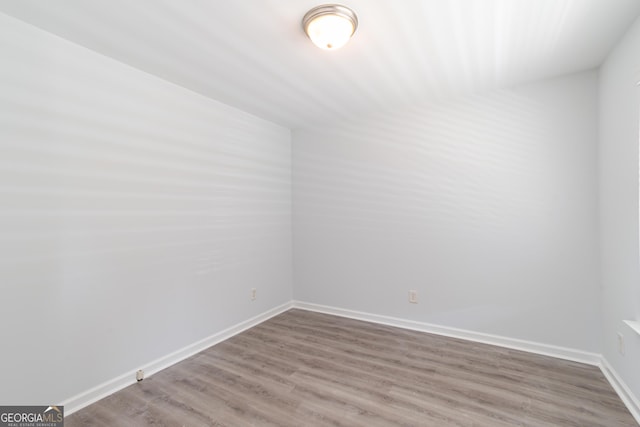 empty room with hardwood / wood-style floors