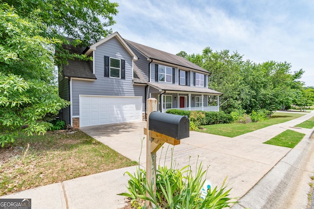 view of front facade with a garage, a porch, and a front yard