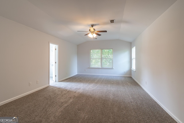 carpeted empty room featuring lofted ceiling and ceiling fan