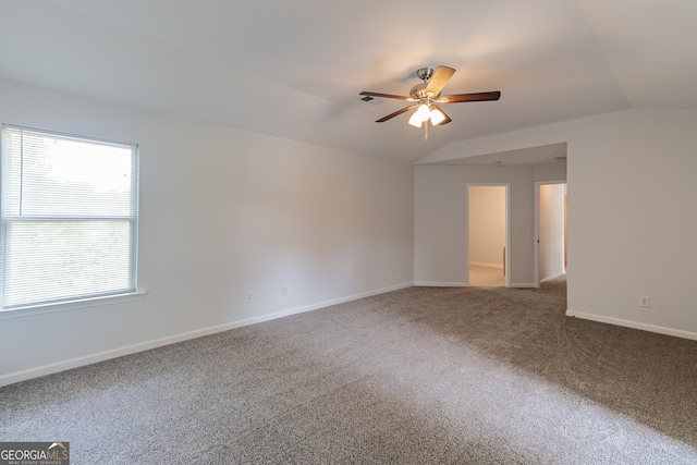 carpeted spare room featuring lofted ceiling and ceiling fan