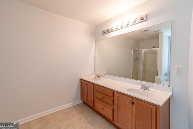 bathroom featuring vanity, a shower with shower door, and toilet