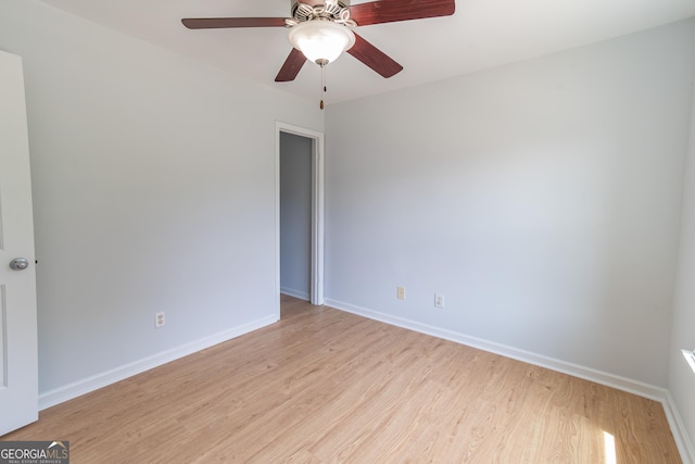 spare room featuring light hardwood / wood-style flooring and ceiling fan