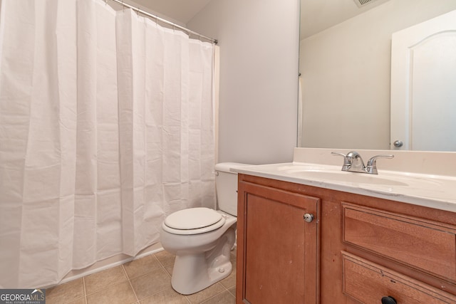 bathroom featuring vanity, tile patterned floors, toilet, and walk in shower