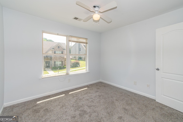 spare room featuring carpet and ceiling fan