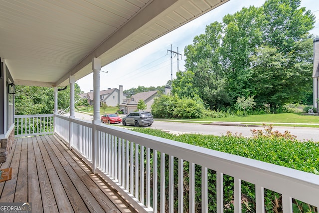 wooden terrace featuring covered porch