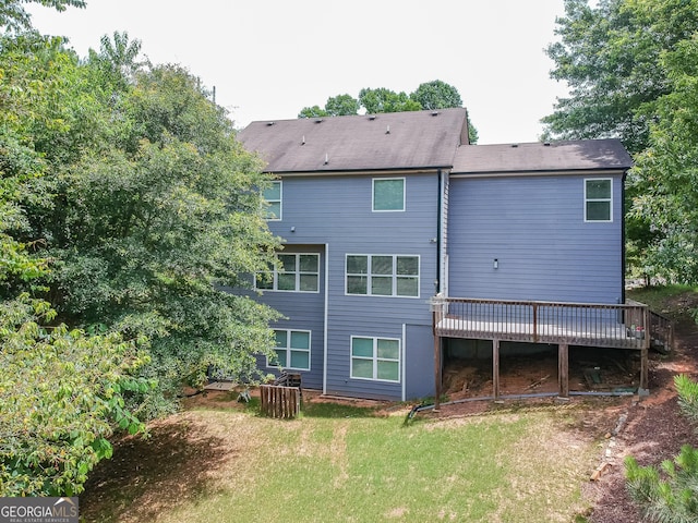 back of house with a yard and a deck