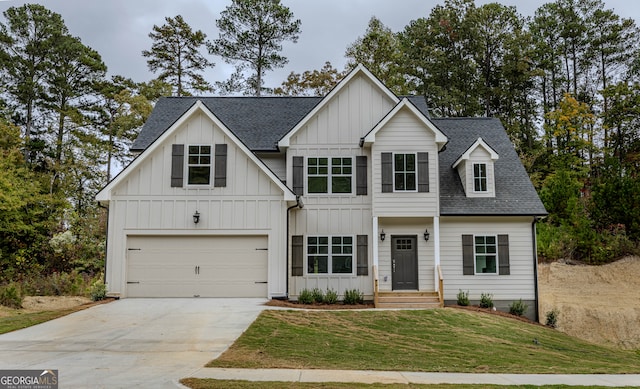 view of front of home with a front yard and a garage