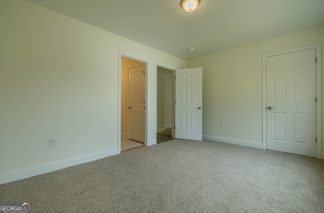 unfurnished bedroom with light colored carpet