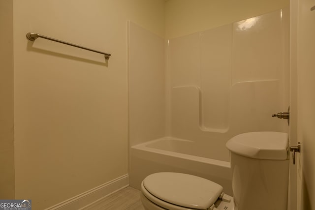 bathroom featuring toilet, shower / tub combination, and hardwood / wood-style flooring