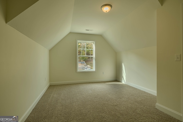 bonus room featuring carpet and vaulted ceiling