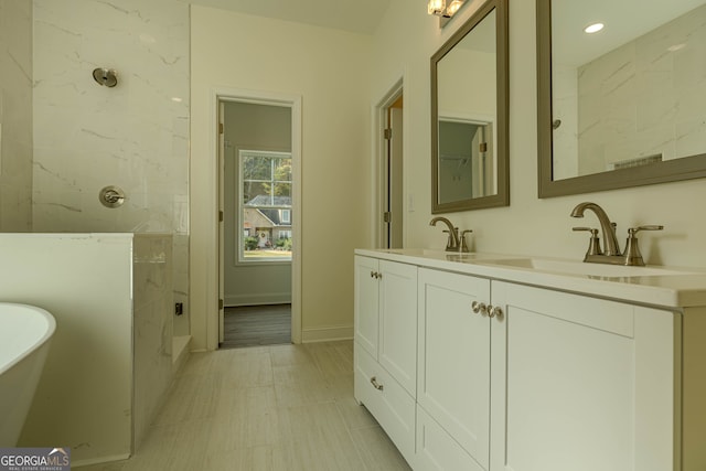 bathroom with vanity and separate shower and tub