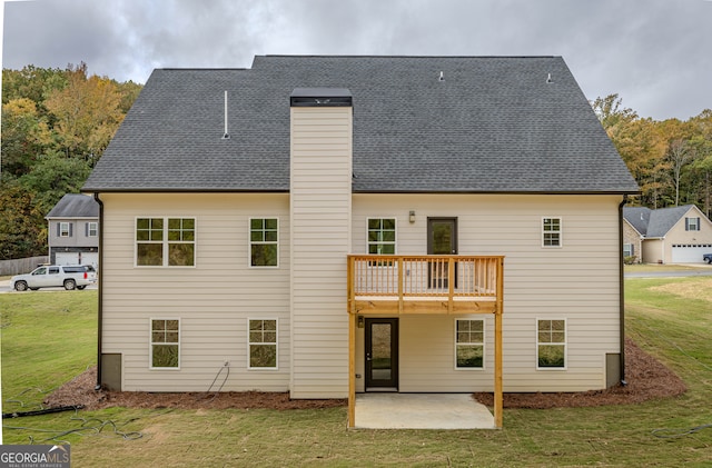 rear view of house featuring a patio area, a lawn, and a balcony