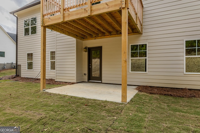 back of property with a patio area and a yard