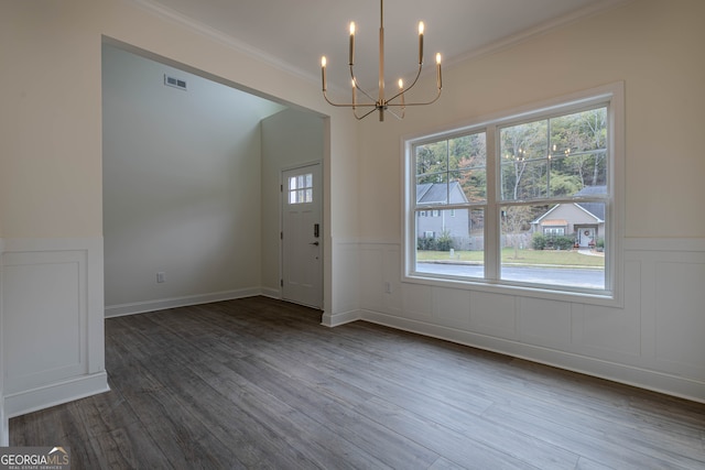 entryway featuring crown molding, wood-type flooring, and a wealth of natural light