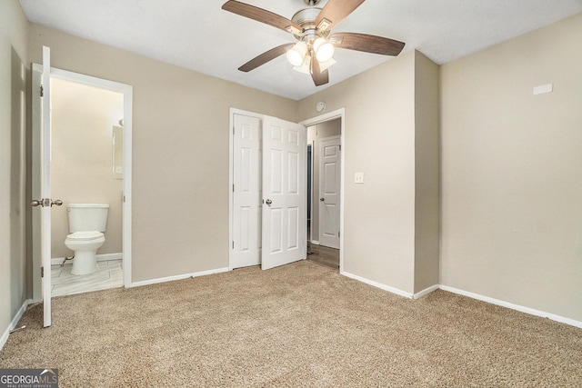 unfurnished bedroom with connected bathroom, carpet, and ceiling fan