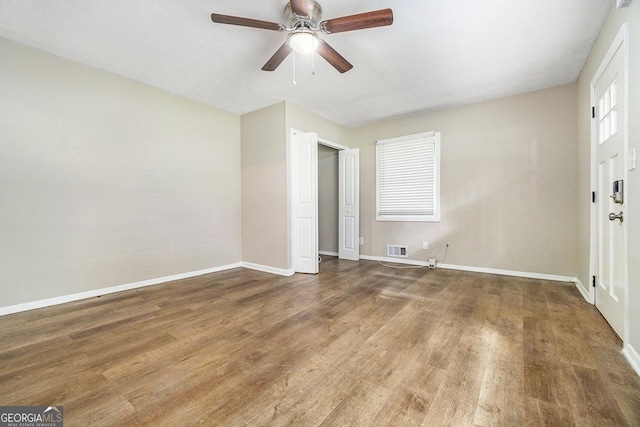 unfurnished bedroom with ceiling fan, a closet, and hardwood / wood-style flooring