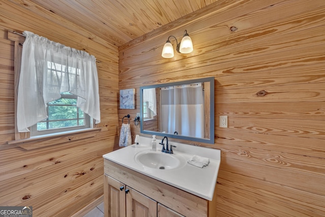 bathroom featuring vanity, wood walls, and wooden ceiling