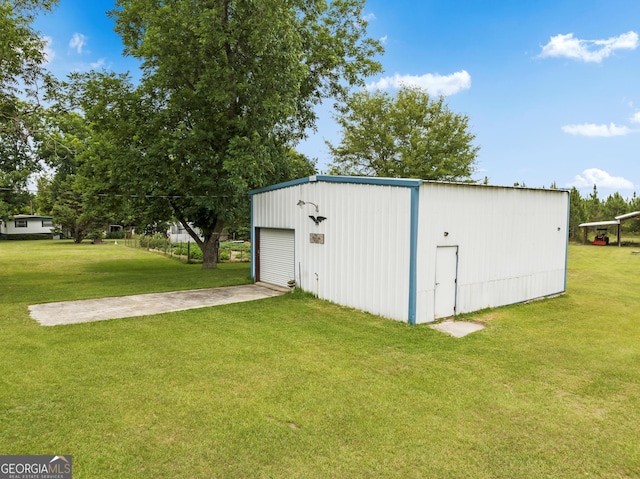 view of outdoor structure featuring a garage and a lawn