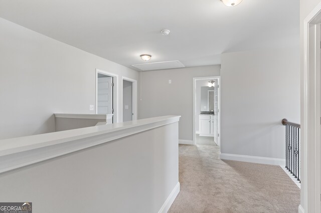 hallway with light colored carpet