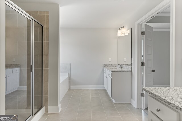 bathroom with tile patterned flooring, vanity, and plus walk in shower