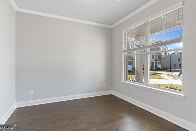 empty room featuring crown molding and dark hardwood / wood-style flooring