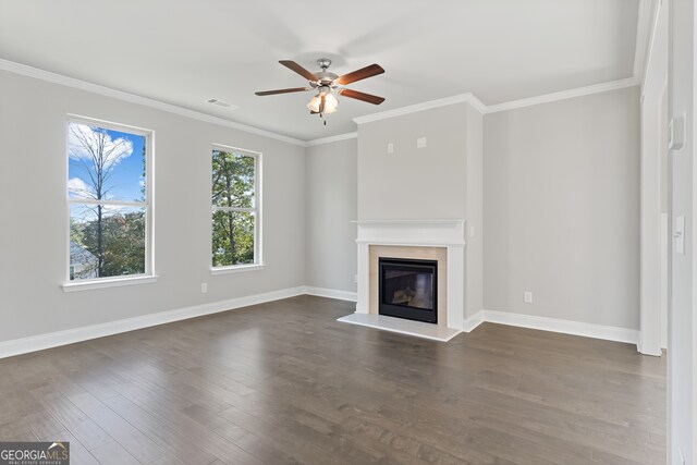 unfurnished living room featuring ornamental molding, ceiling fan, and dark hardwood / wood-style flooring