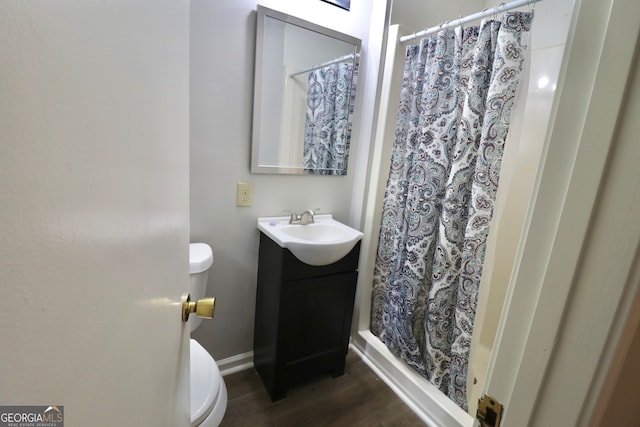 bathroom with hardwood / wood-style floors, vanity, and toilet