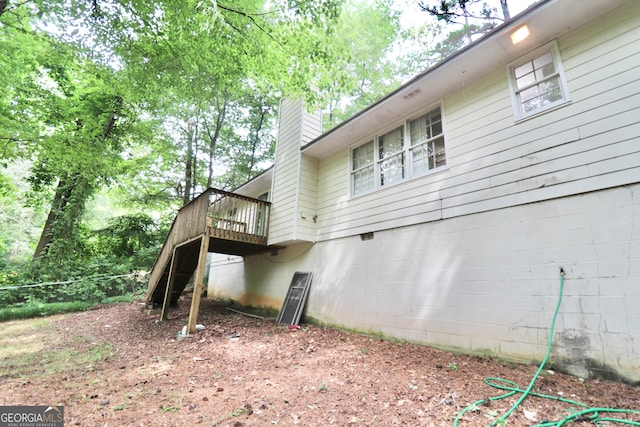 view of side of property featuring a wooden deck