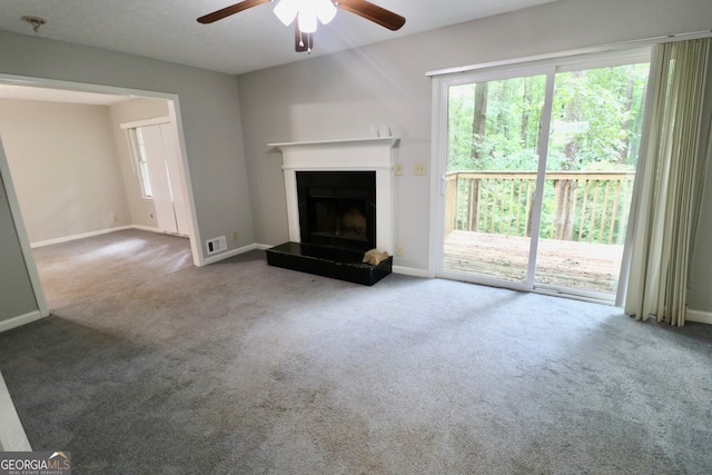 unfurnished living room featuring carpet and ceiling fan