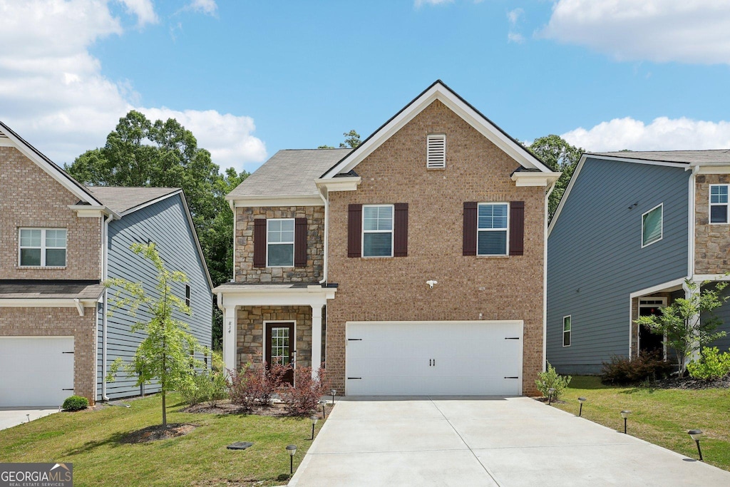 view of front of home featuring a front lawn and a garage