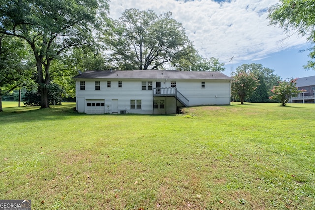 back of property featuring a lawn