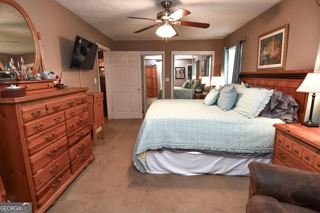 bedroom featuring light carpet and ceiling fan