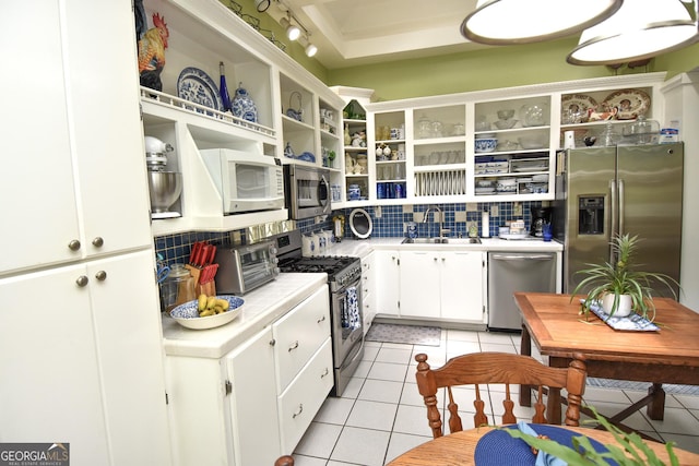 kitchen featuring tasteful backsplash, light countertops, light tile patterned flooring, stainless steel appliances, and open shelves