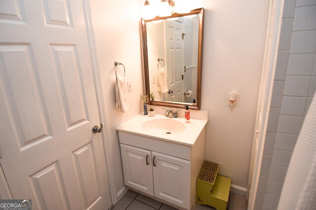 bathroom with tile patterned floors and vanity