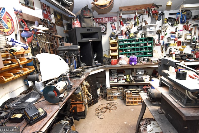 interior space with unfinished concrete flooring and a workshop area