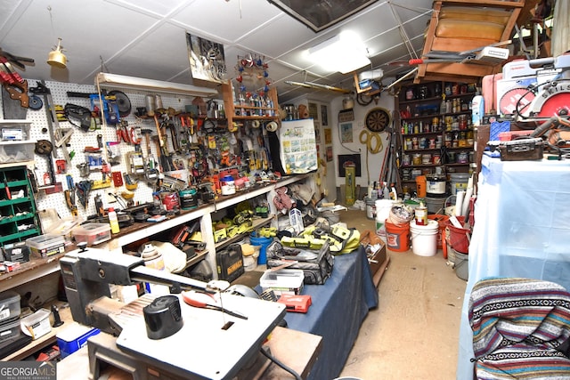 miscellaneous room with a workshop area and concrete flooring