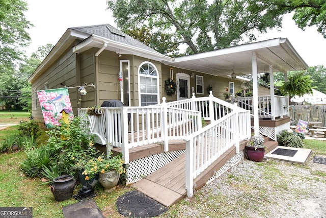 exterior space featuring roof with shingles