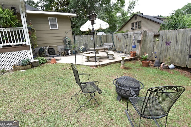 view of yard with a patio area, a fenced backyard, and an outdoor fire pit