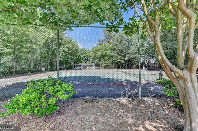 view of swimming pool with tennis court